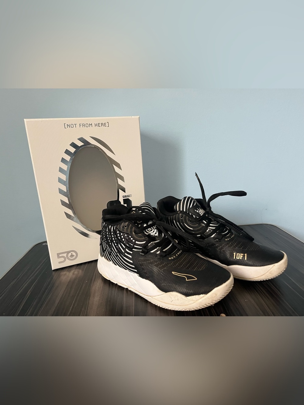 Puma Melo Kids' Black and White Low-Top Sneakers with Gold Accent